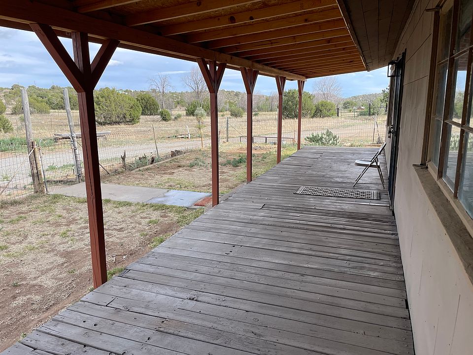 Large front porch with deck, security screen door and a view.
