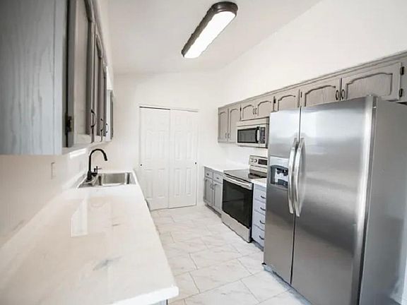 Galley kitchen with all necessary appliances