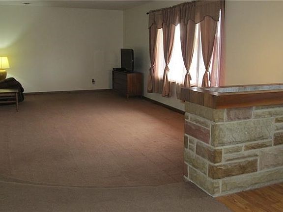 Large, sunken living room with lots of natural light from the south.