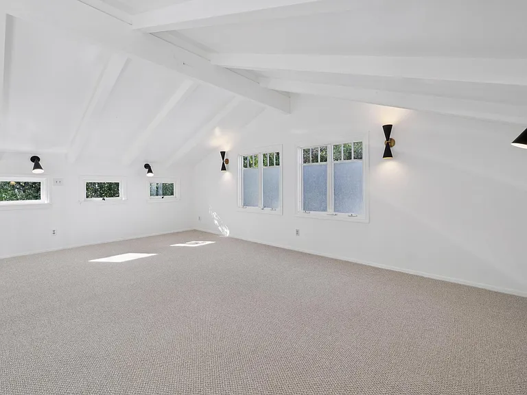 Large loft with new light fixtures, great windows inviting in the light and new carpet.