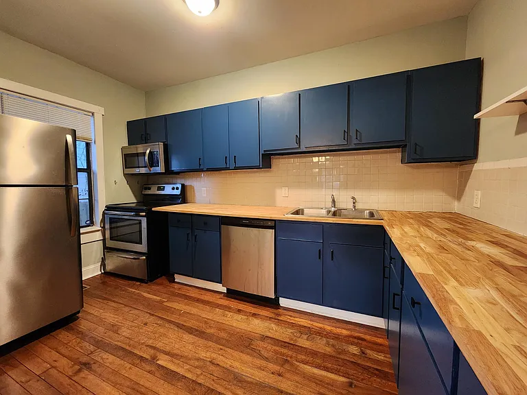 Kitchen with new sanded and painted cabinets and new butcher block countertops. Tons of counter space!