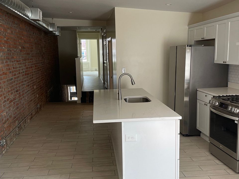 Kitchen with open floor plan from entry to living room to bedroom hallway