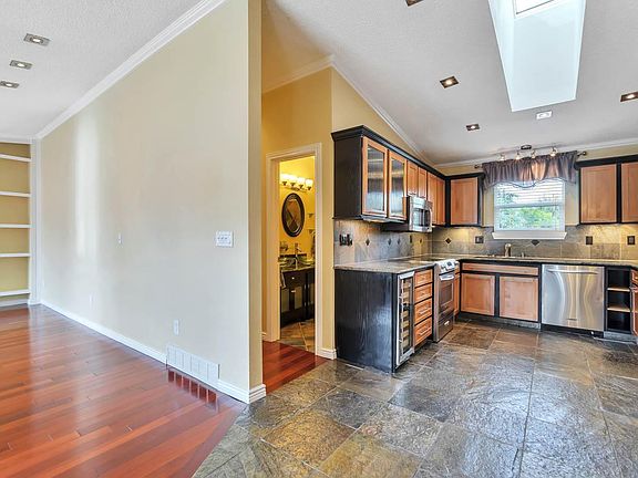 VIEW OF GORGEOUS SLATE FLOOR IN THE KITCHEN & CHERRY HARDWOOD IN THE LIVING ROOM