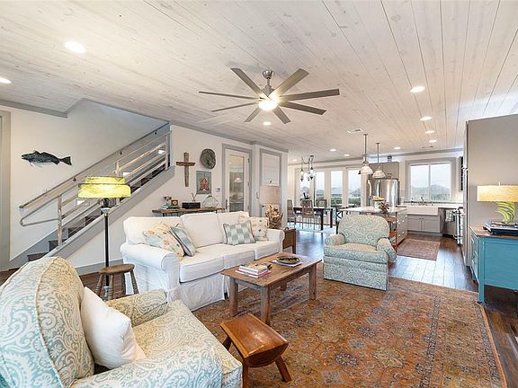 Open living/kitchen/dining areas have shiplap ceilings, high impact doors & windows allowing plenty of natural sunlight, wood floors & gas fireplace.
