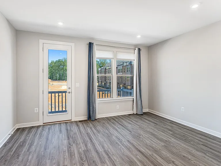 Open and airy living room seamlessly connects to a private balcony, creating the ideal indoor-outdoor living experience.