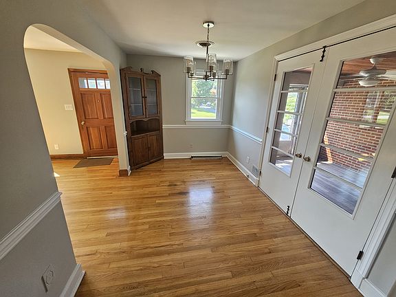 Dining room with refinished wood floors, built in China cabinet and new light fixture.