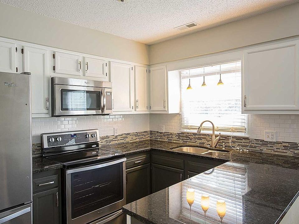 Full suite of Stainless Steel Appliances, Dark granite counter tops, custom tile backsplash