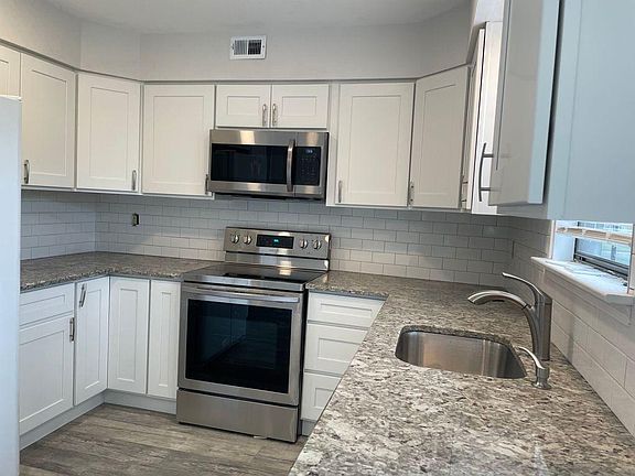 Brand new kitchen with granite counter tops and stainless steel appliances