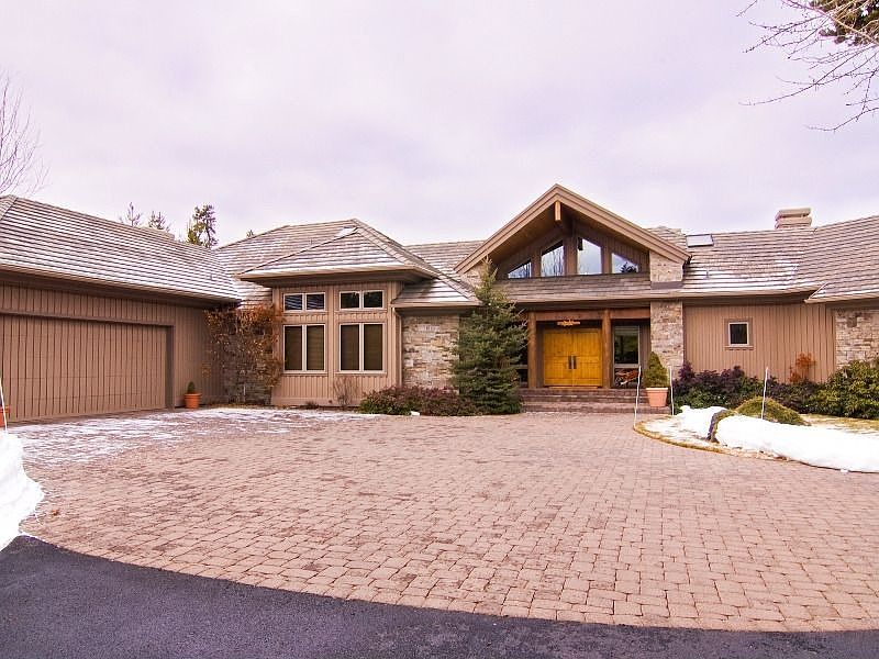 Beautiful Curb Appeal with Paver Stones, True Board &amp; Batt Siding and Tile Roof