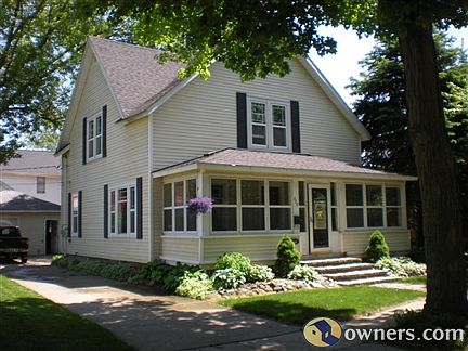 Front of home with large enclosed front porch