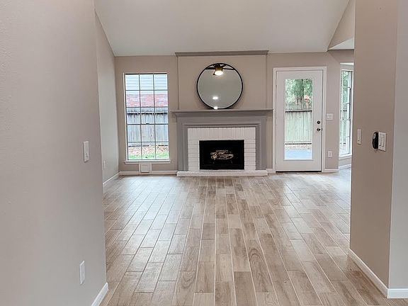 Open and spacious family room with gas burning fireplace and opening to deck + back yard.