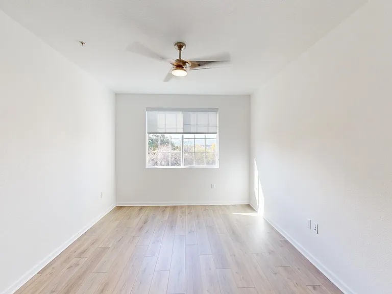 Apartment bedroom with wood style floor.
