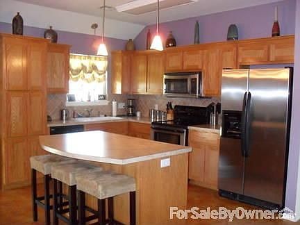 Kitchen : Beautiful stainless appliances compliment this open kitchen with large island.