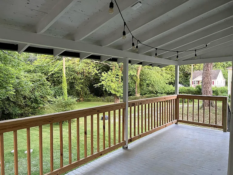 Cozy balcony off kitchen with large, flat backyard.