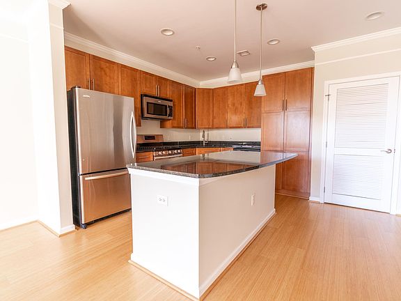Open gourmet kitchen with gas cooking, Granite & Stainless Steel Appliances -- Note the Bamboo Floors.