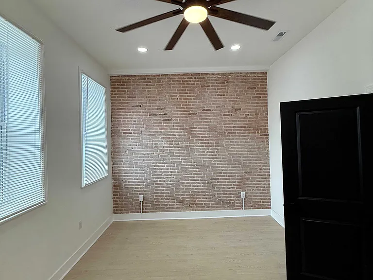 Bedroom with exposed brick.