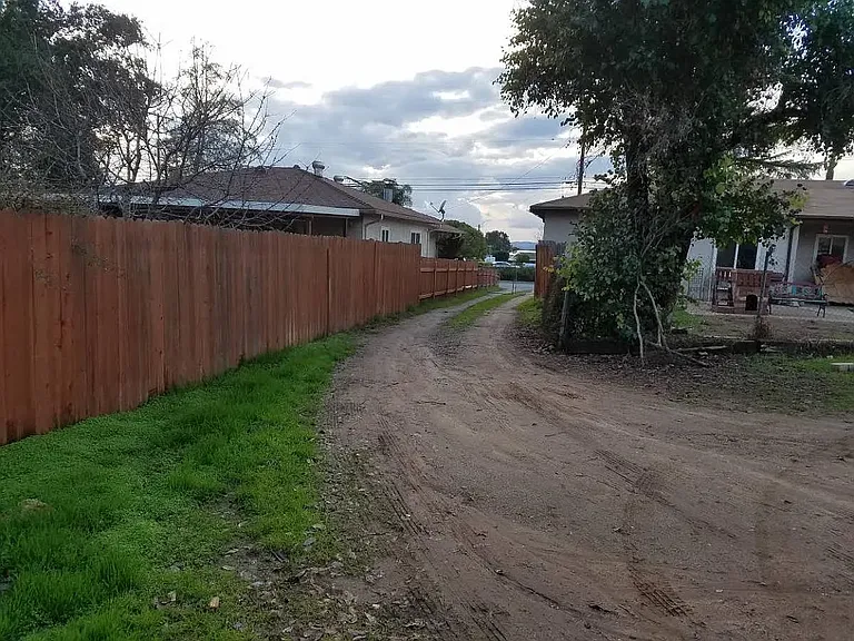 driveway which has locked gate to enter into the large yard