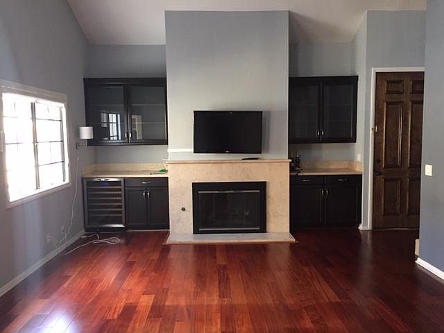 Living room, fireplace, wine fridge and storage.