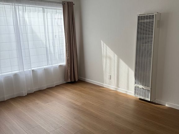 Living room with new floors, paint and drapes