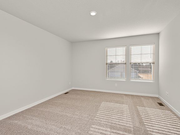 The master bedroom is spacious with a large window.