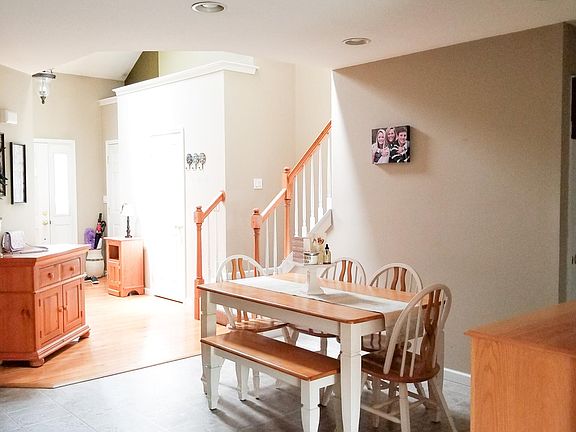 Eat-in kitchen with open floor plan to entry and living room.
