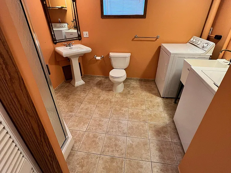 laundry and laundry sink in lower bathroom.