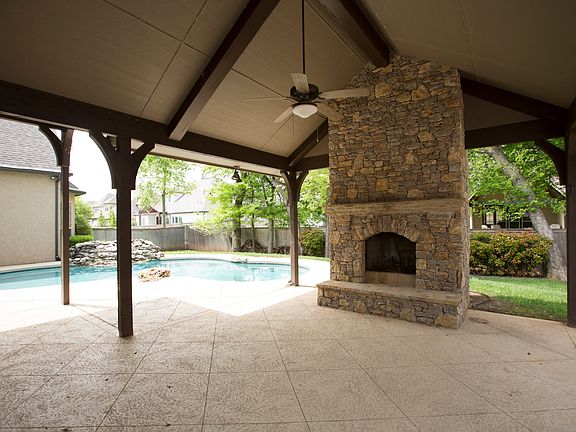 Scored cool decking continues into the vaulted and beamed Outdoor Living area complete with gorgeous