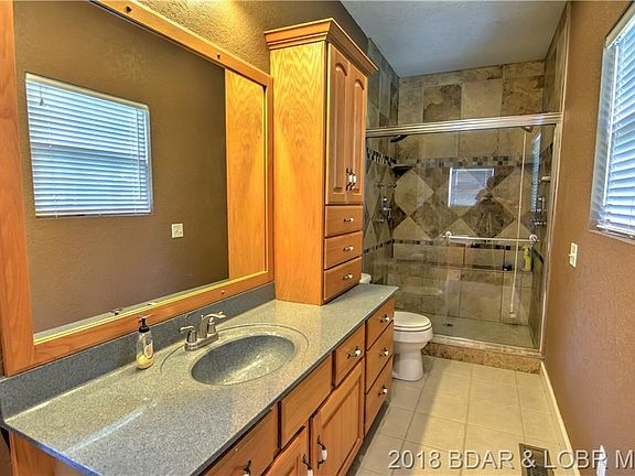 The master bath holds a jetted tub, walk-in shower, and large vanity.