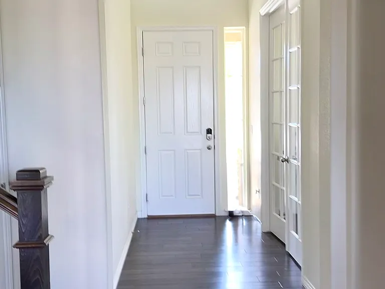 Front hallway sun dappled from two story overlook.