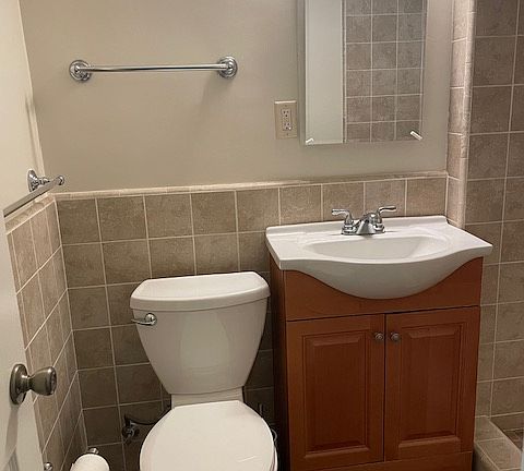 Towel bars and newer toilet with new Toilet seat cover and medicine cabinet