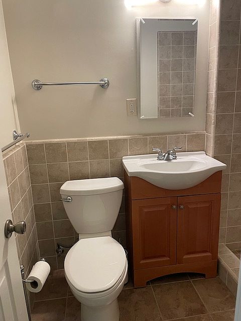 Towel bars and newer toilet with new Toilet seat cover and medicine cabinet