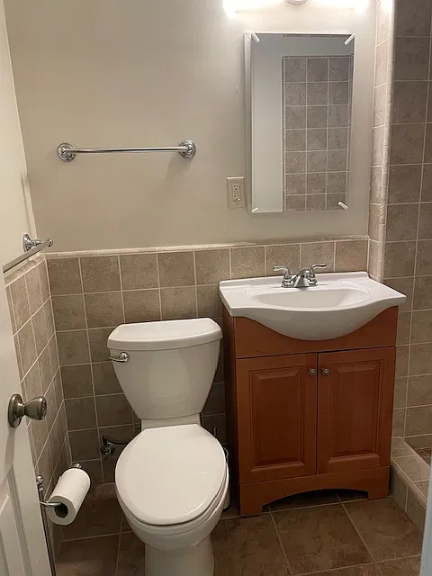 Towel bars and newer toilet with new Toilet seat cover and medicine cabinet