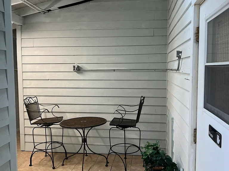 Indoor patio entryway. Skylight has lots of natural light. There is a garden faucet around the corner for plants.