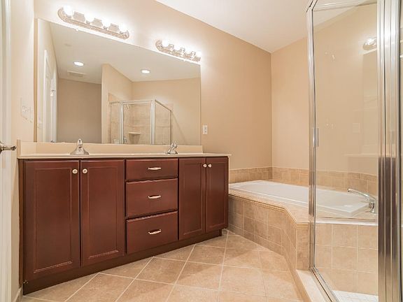 Primary Bath Features Dual-sink Vanity, Soaker Tub, and Large Shower