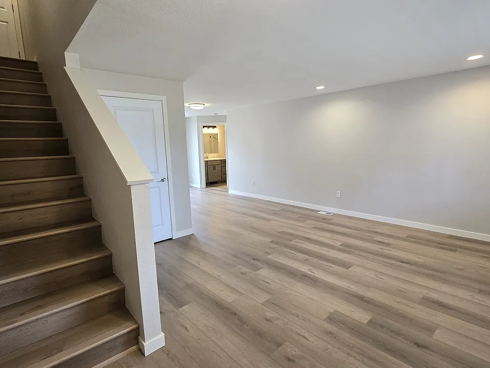 Front entry view. Stairs up on the left. Storage closet, new flooring.