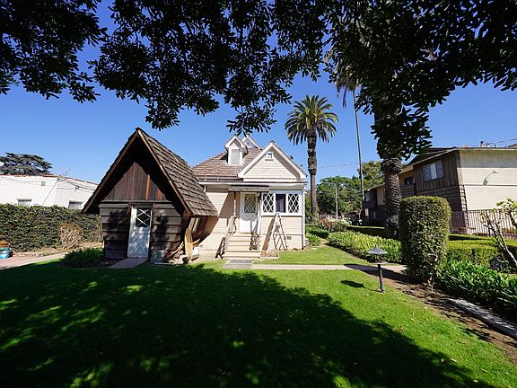 Back door and play house (shed) with a very large tree for shade