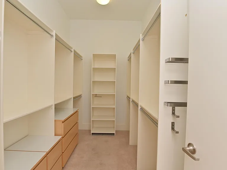 Large master closet 1 with custom cabinetry.