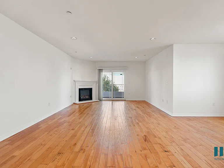 Open-Concept Dining and Living Room Areas with Electric Fireplace, Vinyl Flooring, and Patio
