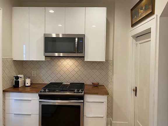 Remodeled Kitchen with Tile Backsplash, Wood Countertops and New Appliances