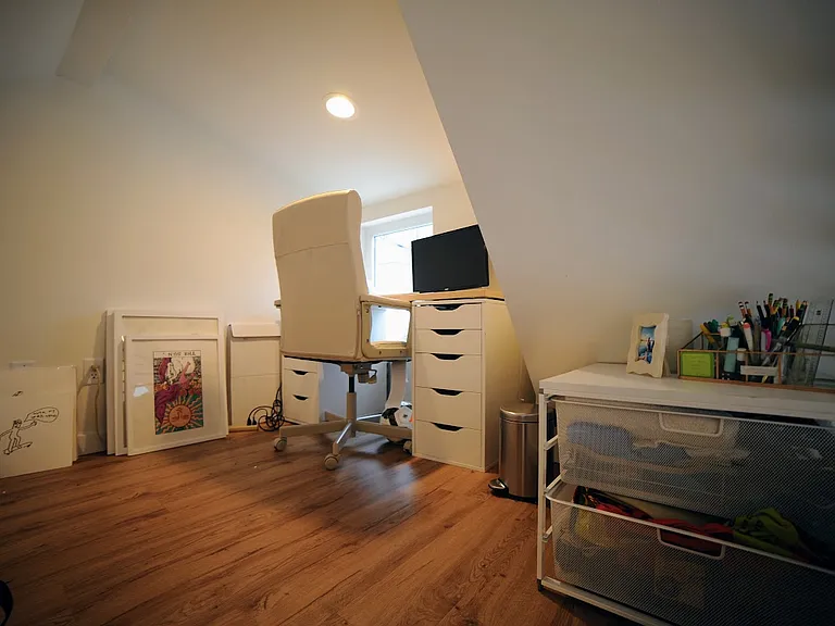 Loft is furnished with lots of built in storage, a desk and chair