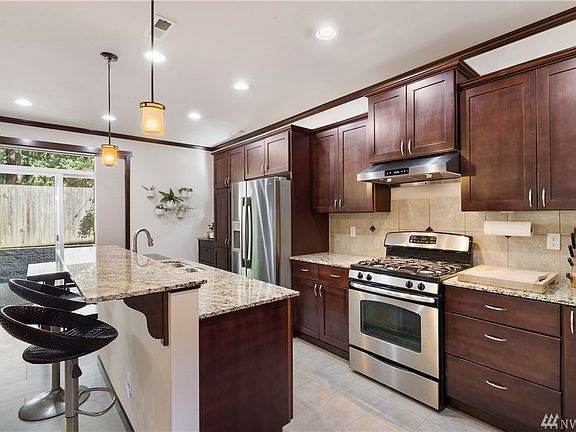 Counter height bar seating for guests and slider door leads to low maintenance backyard. Community has a large Playground and Basketball court steps away.