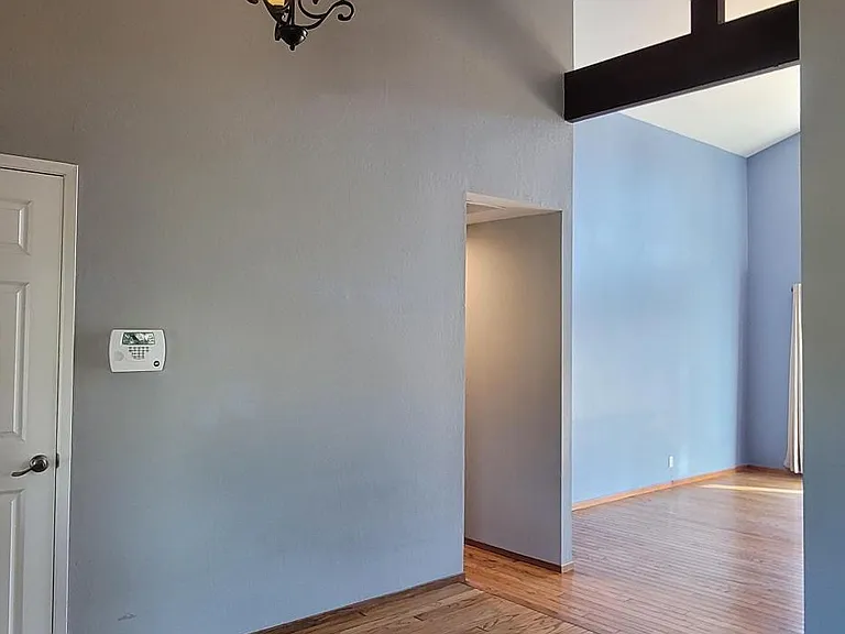 Open floor plan with dramatic vaulted ceilings and architectural beams.