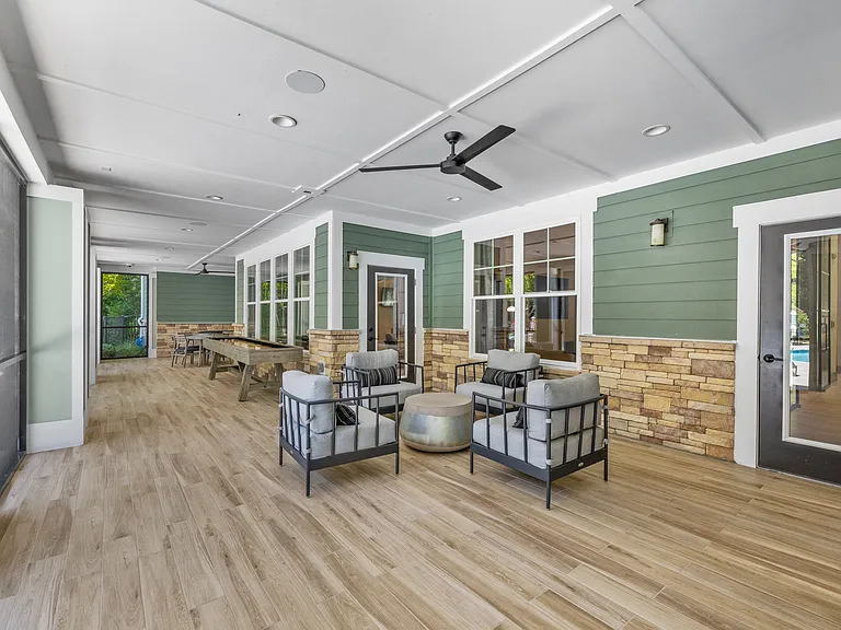 Langley Pointe Apartments | Screened in Patio w/ Seating Area