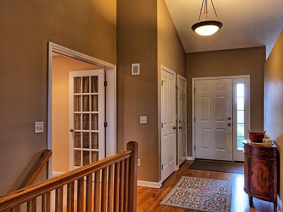 Foyer with closets.  Space to left is either a bedroom or home office