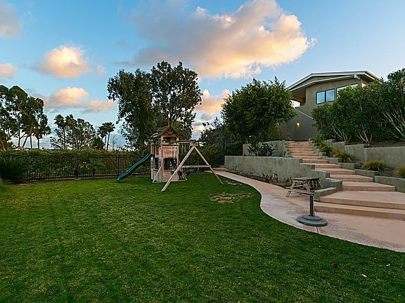 The lower part of the backyard has a great flat space to play or build your dream pool!