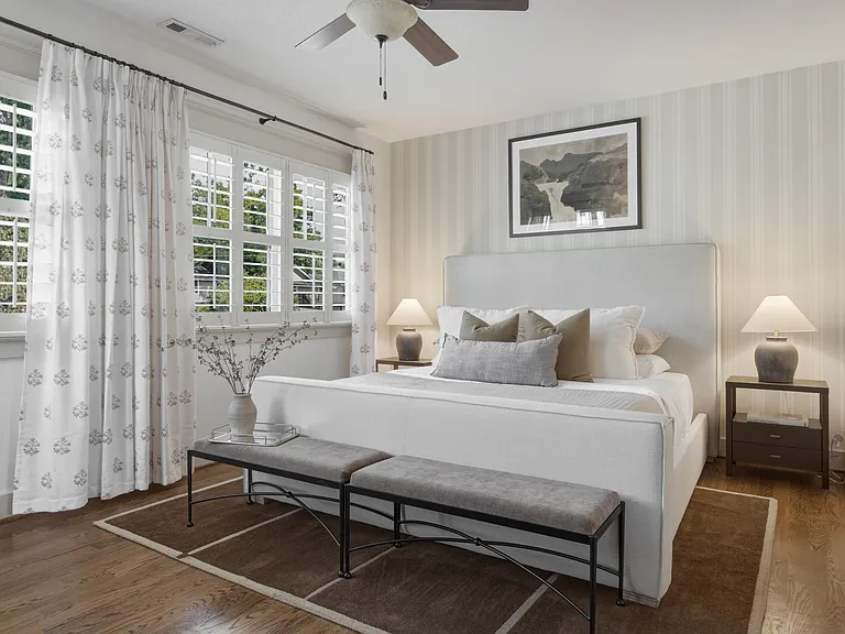 The primary suite features a king-sized bed, huge walk-in closet, ceiling fan, dresser, smart TV, and ensuite bathroom.