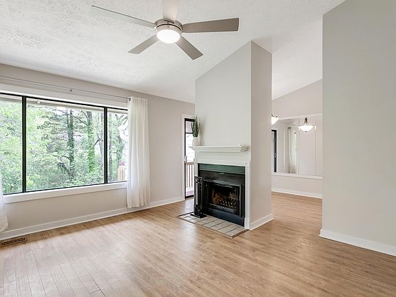 Large family room with vaulted ceiling & wood burning fireplace