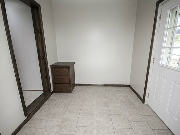 You enter the home to walk into a sizable breezeway.