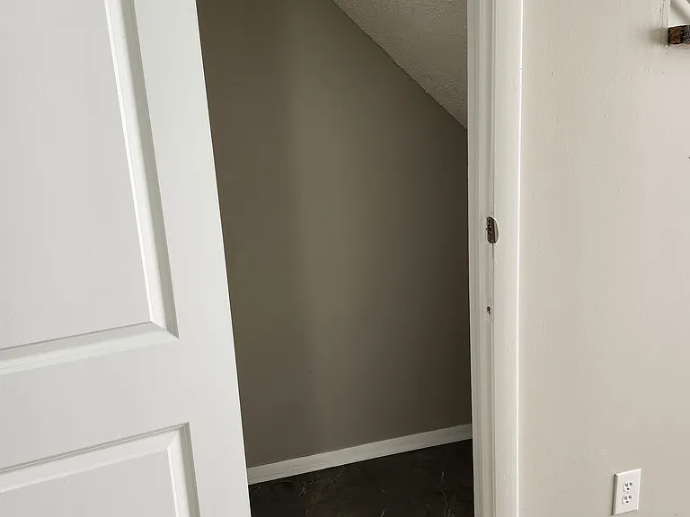 View of under the stairs "storage area." New tile flooring.