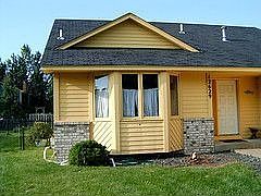 New siding is some places of the house and new landscaping in the front.